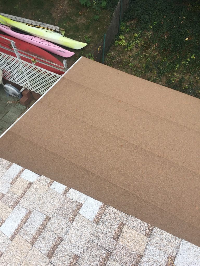 A cardboard box sitting on top of a brick wall.