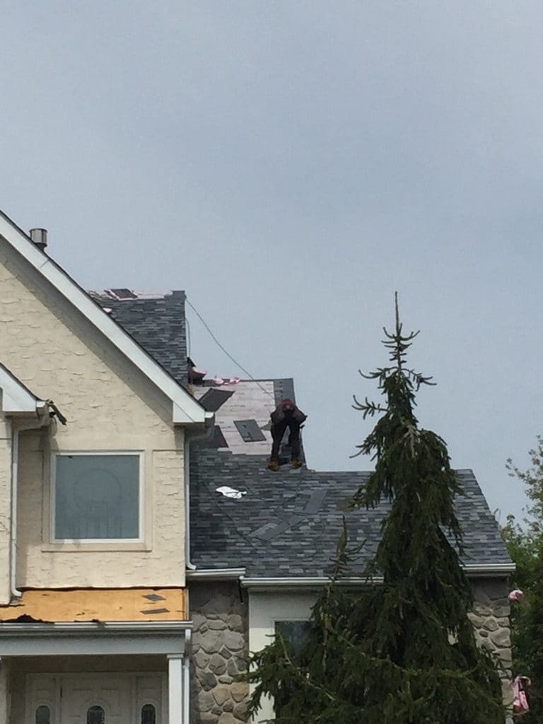 A man standing on top of a roof.