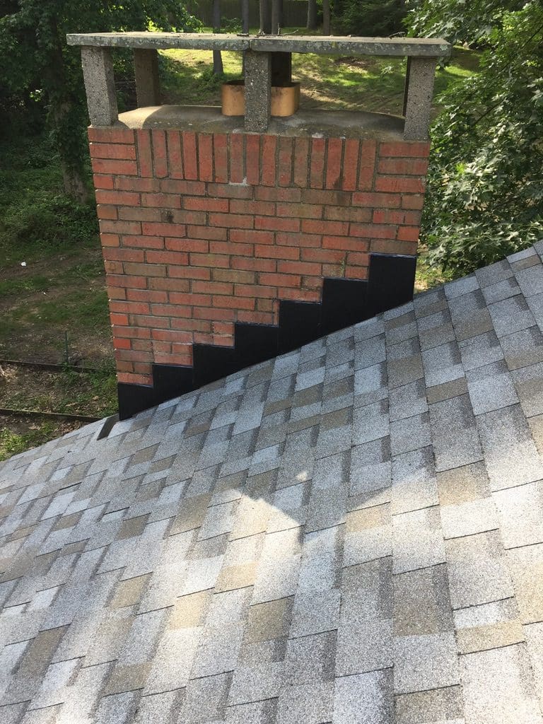 A brick chimney and roof with the chimney removed. Types of nj roofers roof repair east brunswick New Jersey