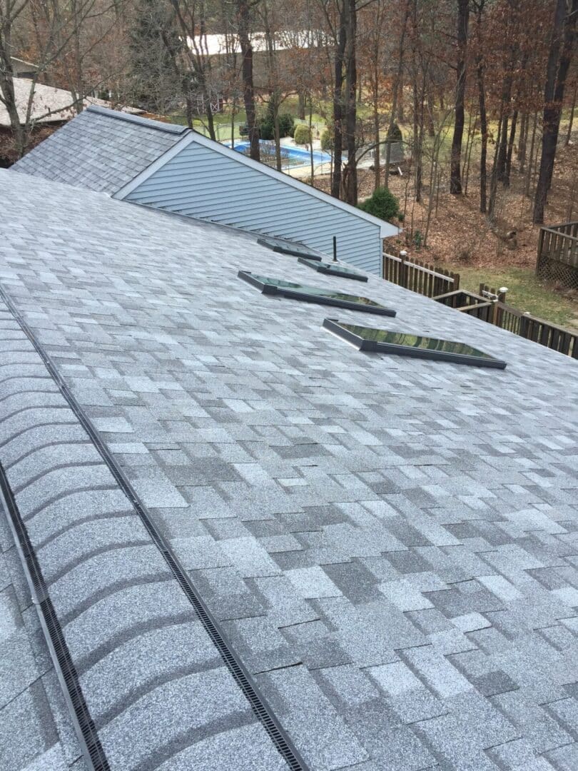 brand new gray colored roof shingles on a house.