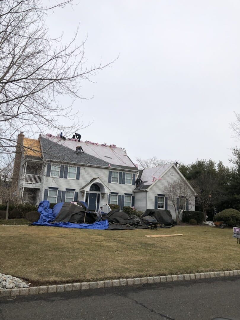 A house with some tarps on the roof