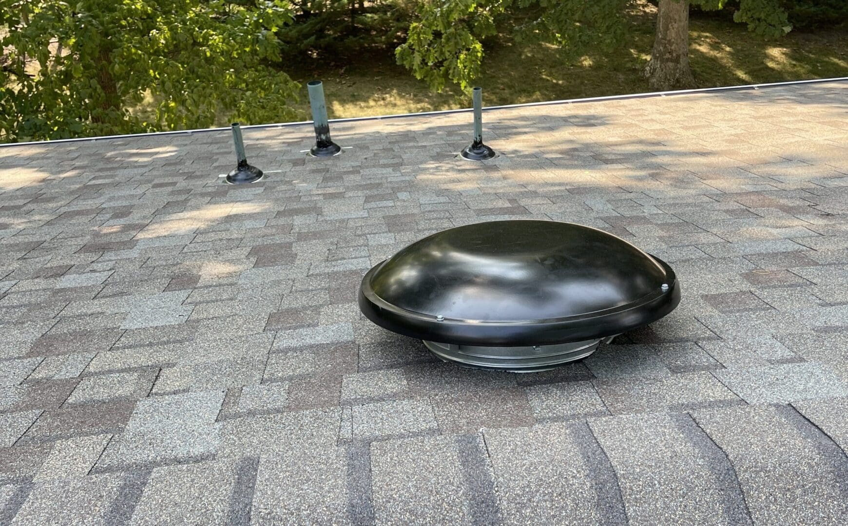 A black object sitting on top of a brick walkway.