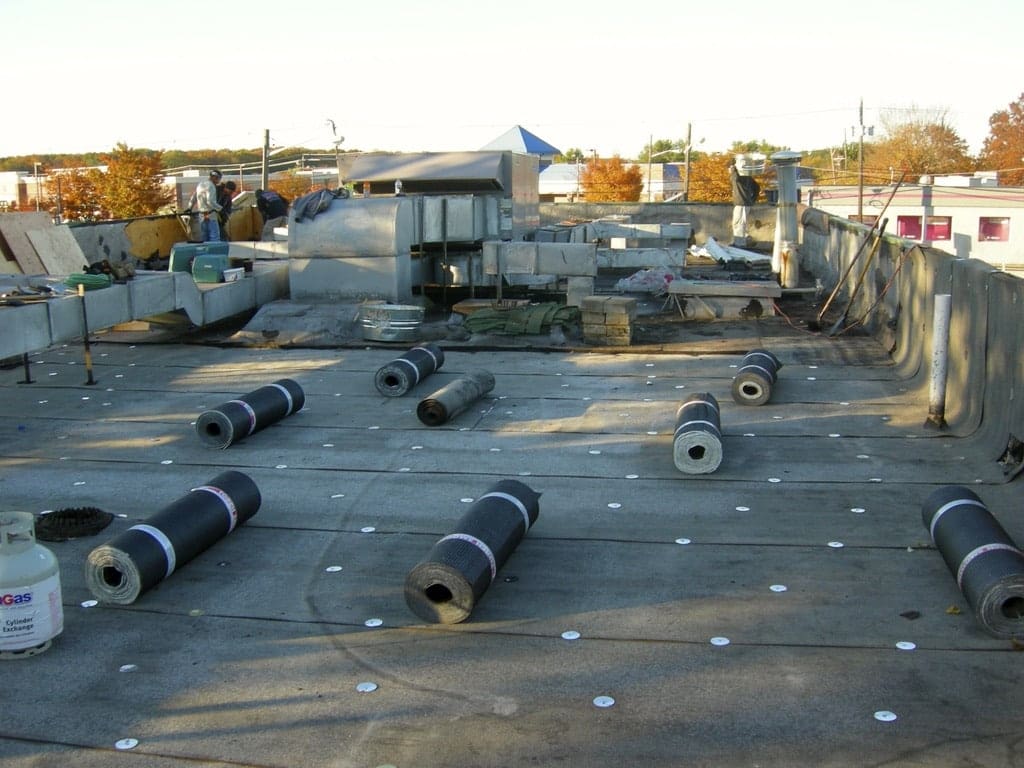 A lot of pipes laying on top of the roof.