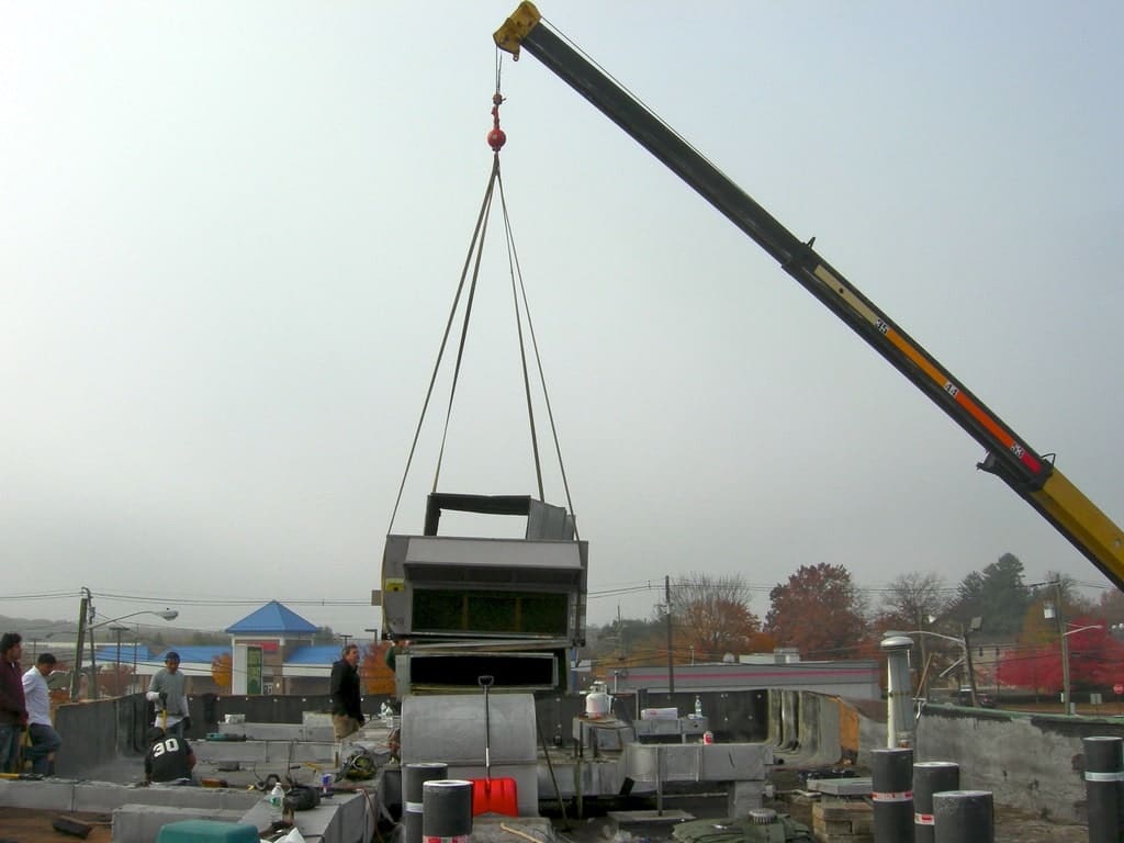 A crane is lifting a large metal object.
