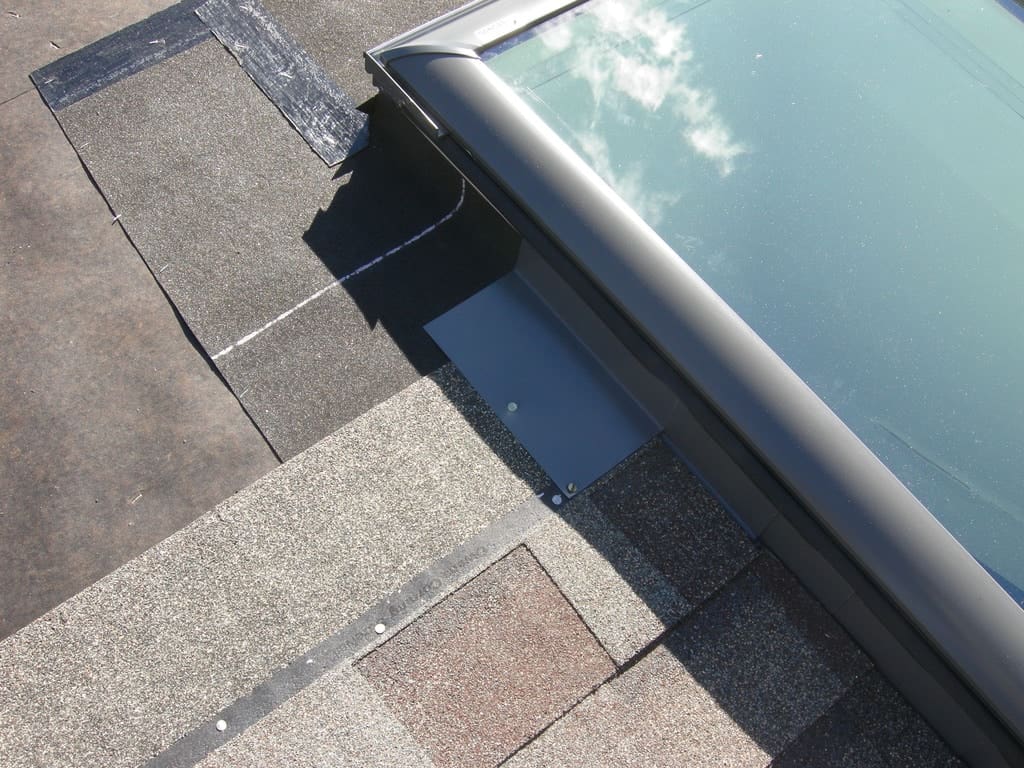 A skylight in the process of being installed on a roof.