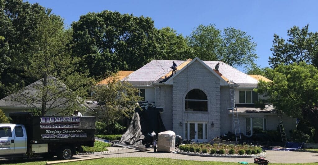 New Roof Replacement, A house with some people working on it