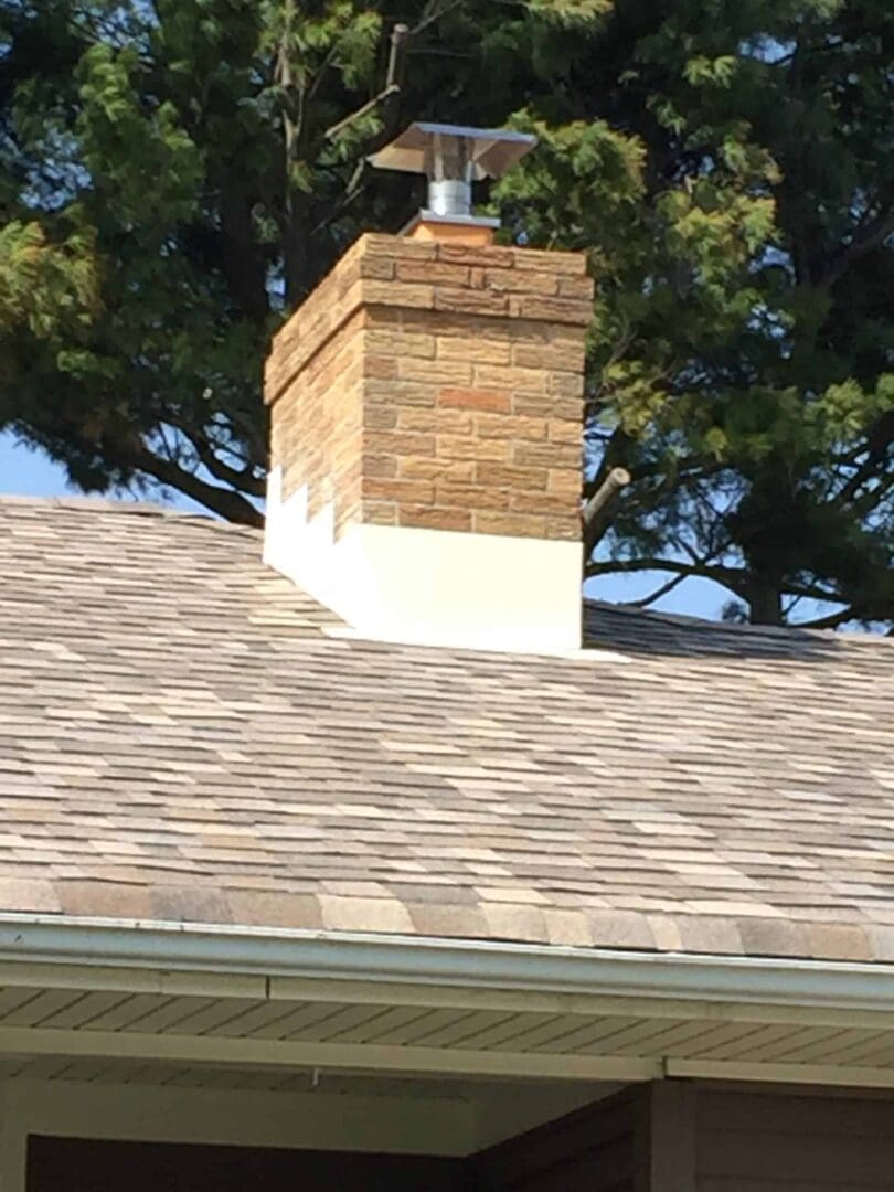 A brick chimney on top of a roof.