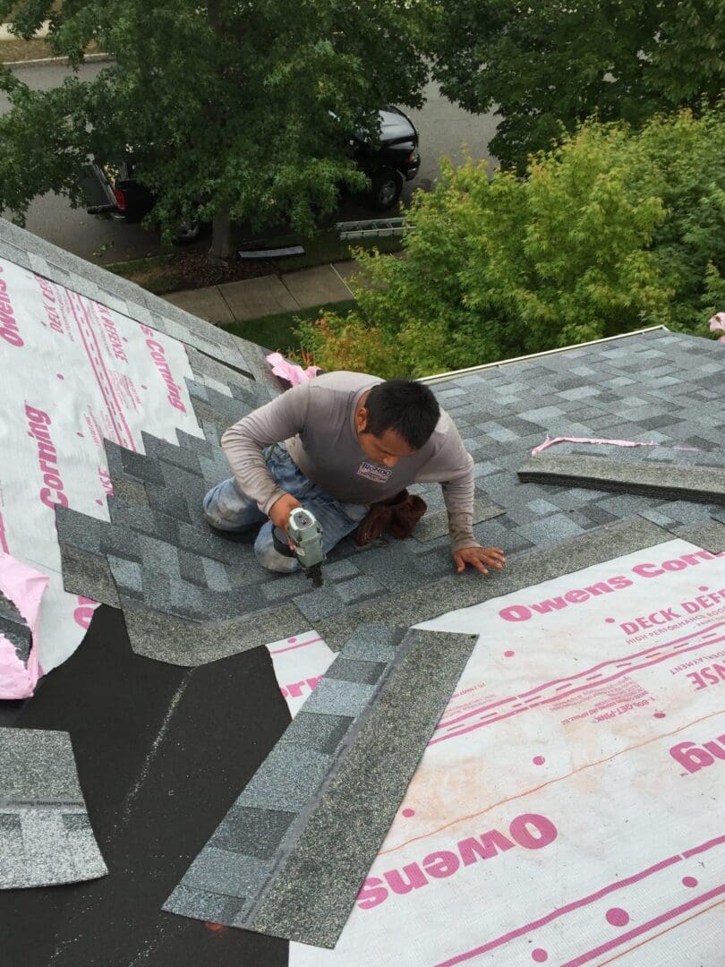 A man working on the roof of a home.