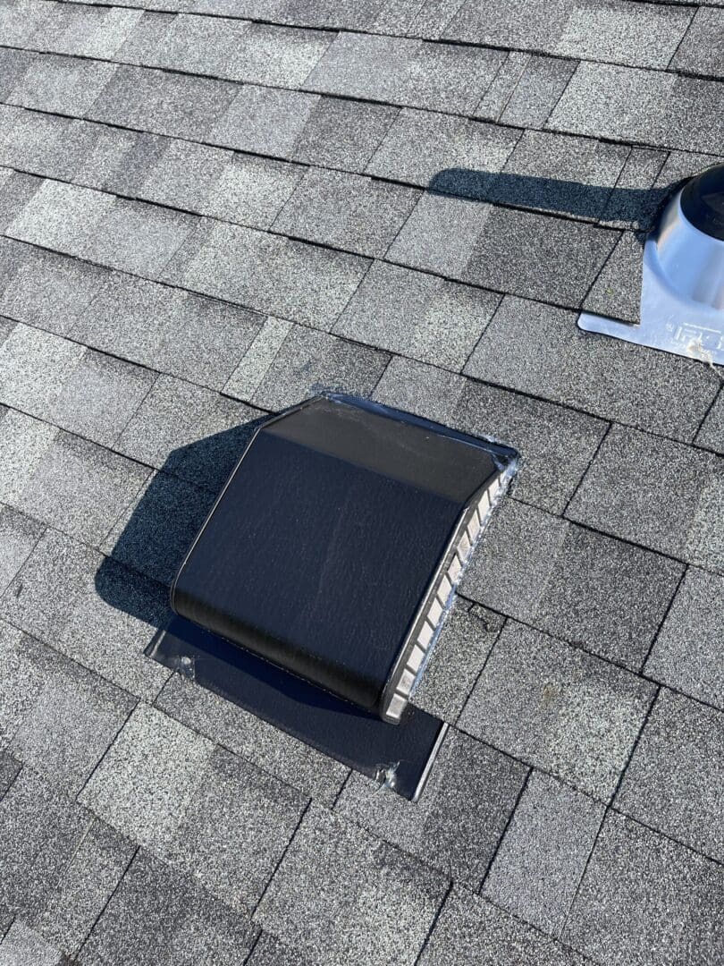 A roof vent on top of a house.