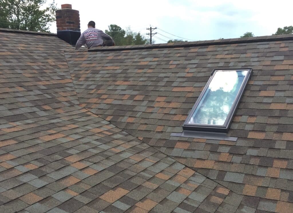 A man standing on roof with NJ Roofing Installations