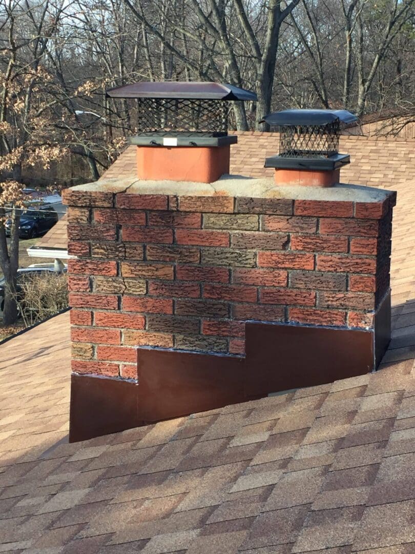 A brick chimney with two different types of chimneys flashings.