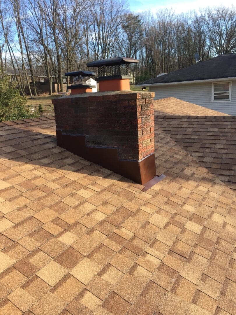 A brick chimney with a metal roof on top of it.