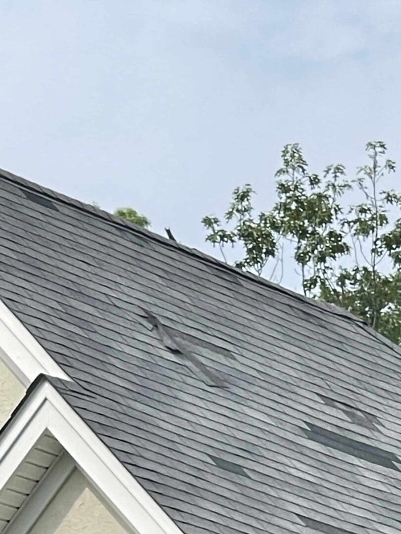 missing shingles on the roof of a house.