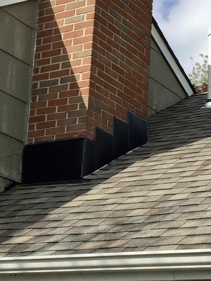 A close up of the roof and chimney on a house