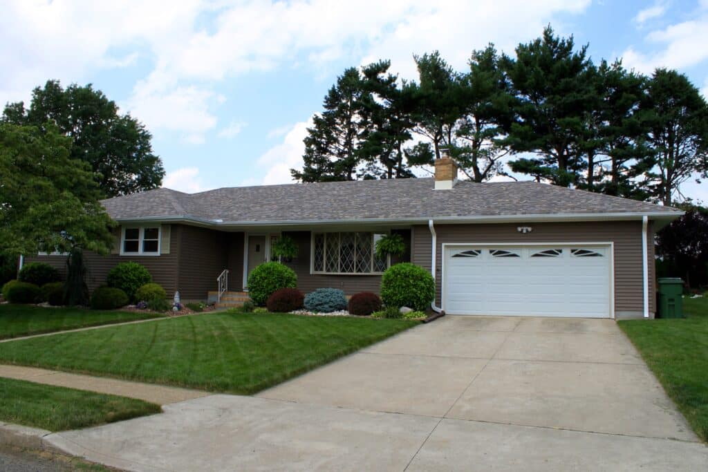 Image of a ranch  new jersey roofing company installed shingles and clay colored siding.